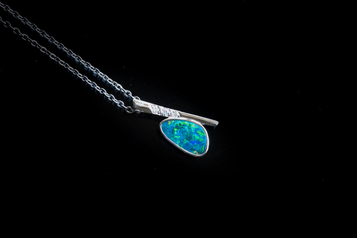 Necklace with a blue opal pendant on a black background