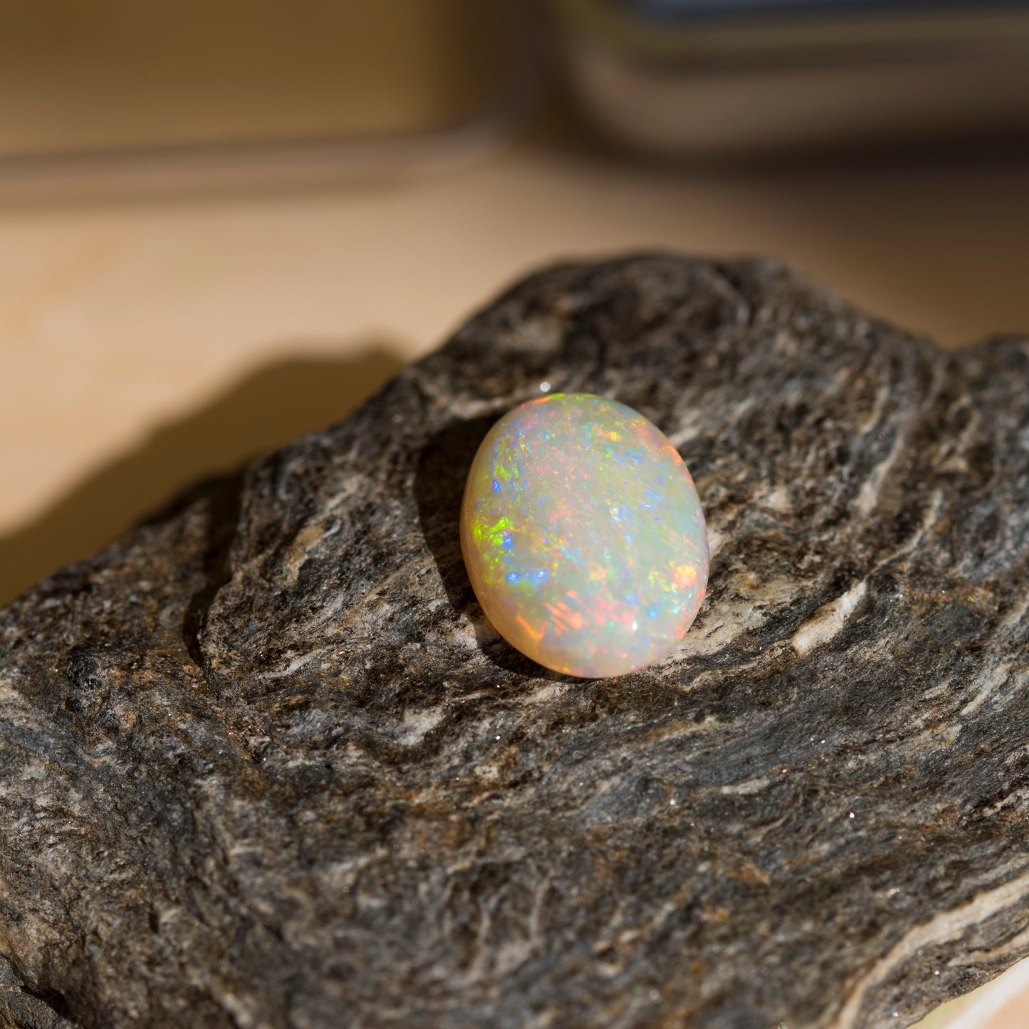 Opal stone on a dark rock surface