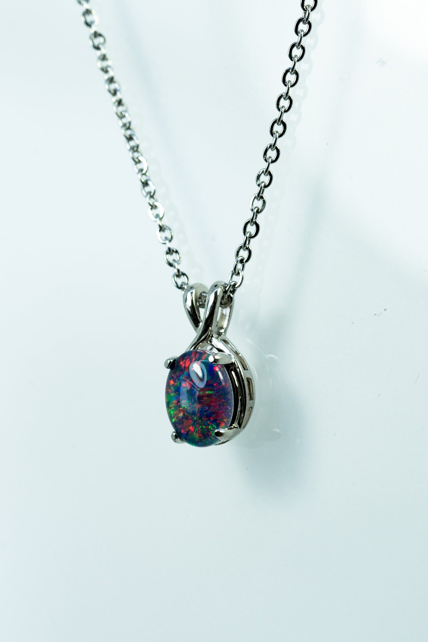 Opal pendant necklace on a white background