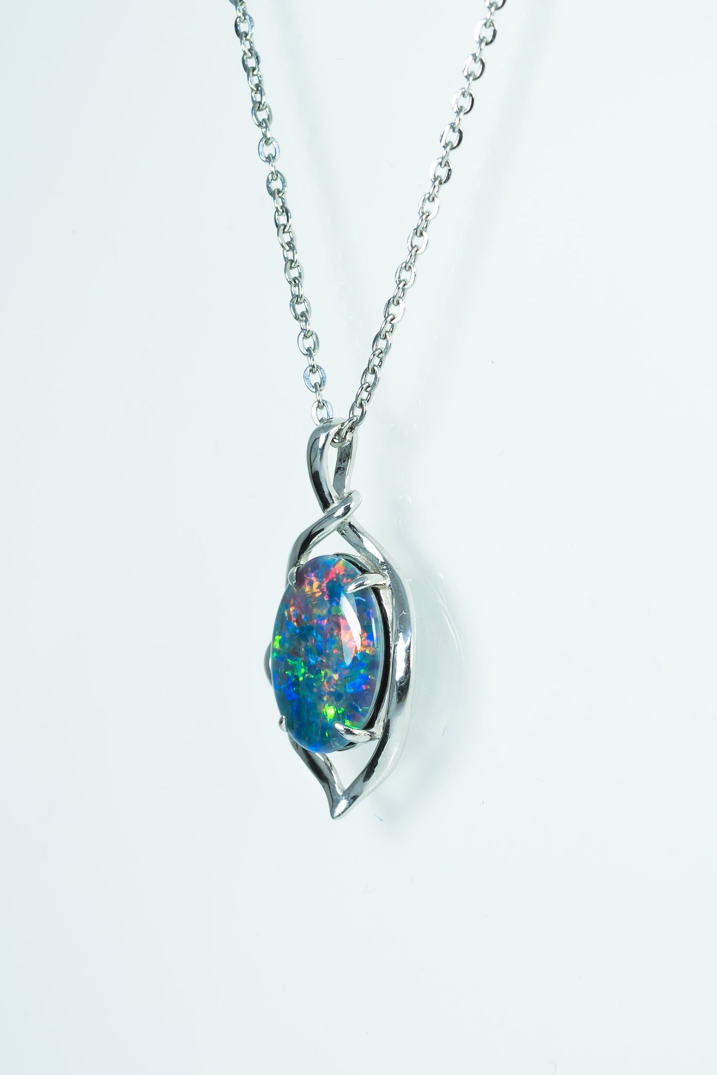 Opal pendant necklace on a white background