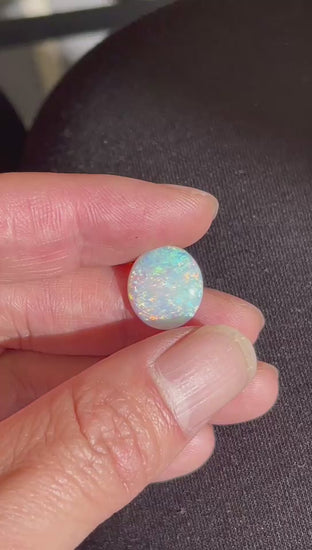 opal gemstone on hand
