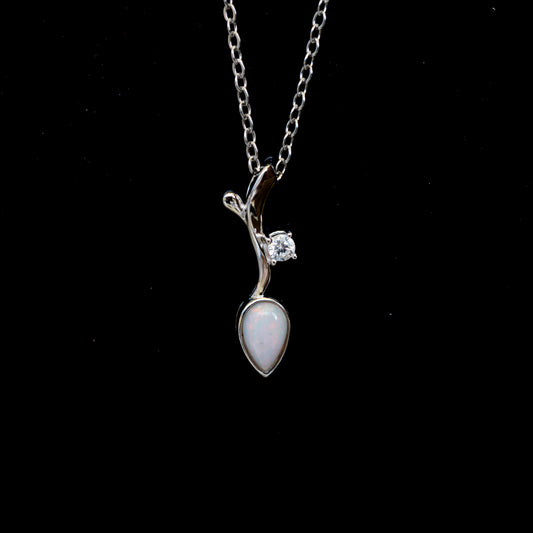 Silver necklace with a pendant featuring a teardrop-shaped opal gemstone on a black background