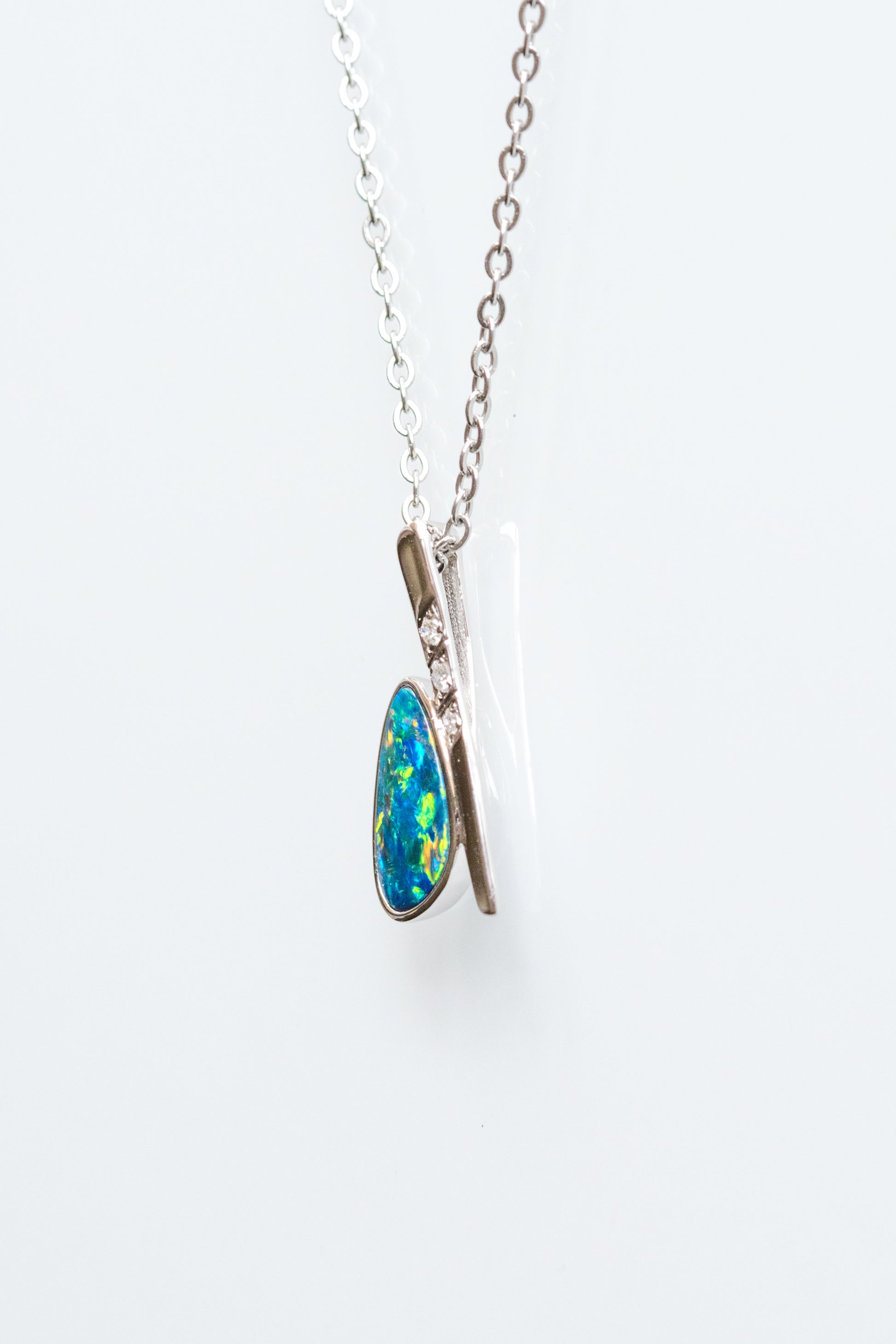 Necklace with a blue and green Opal pendant on a white background